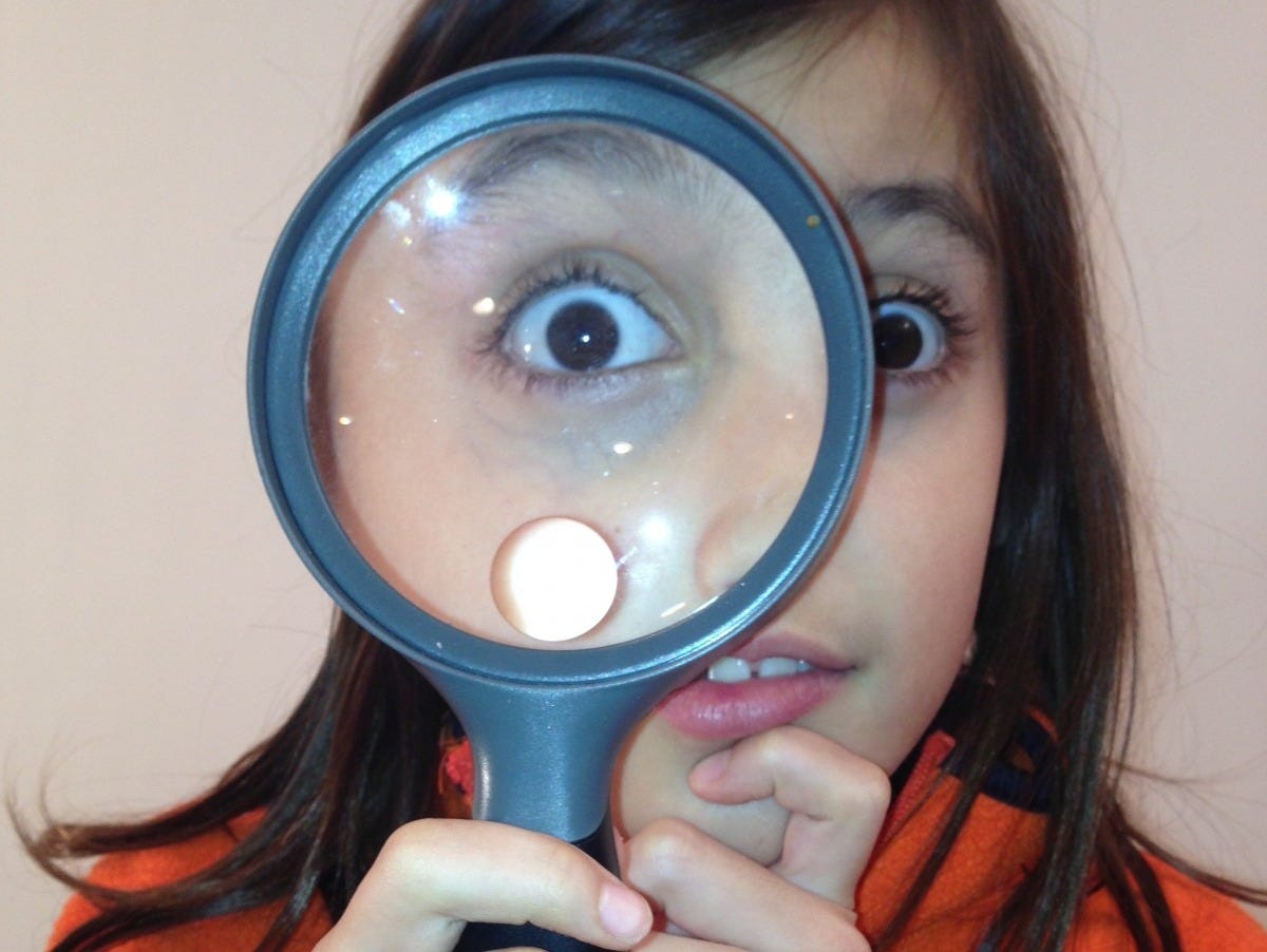 hand, girl, finger, student, blue, clothing, ear, mouth, magnifying glass, research, human body, face, nose, science, eye, glasses, head, discovery, organ, costume, lab, scientific, scientist, sense, loupe, vision care