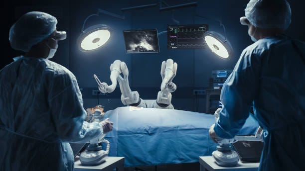 Two Surgeons Wearing Augmented Reality Headsets And Using High-Precision Remote Controlled Robot Arms To Operate On Patient In Futuristic Hospital. Doctors Working With Robotic Limbs, Observing Vitals Two Surgeons Wearing Augmented Reality Headsets And Using High-Precision Remote Controlled Robot Arms To Operate On Patient In Futuristic Hospital. Doctors Working With Robotic Limbs, Observing Vitals AI and robotics healthcare stock pictures, royalty-free photos & images