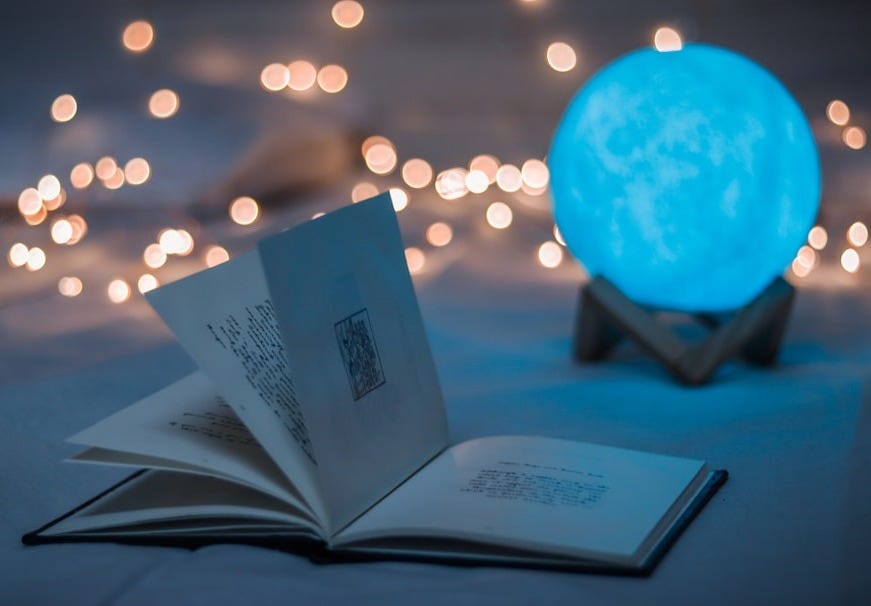 opened book beside crystal ball opened book beside crystal ball
