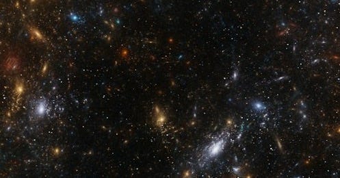 A vibrant nebula filled with stars and galaxies.