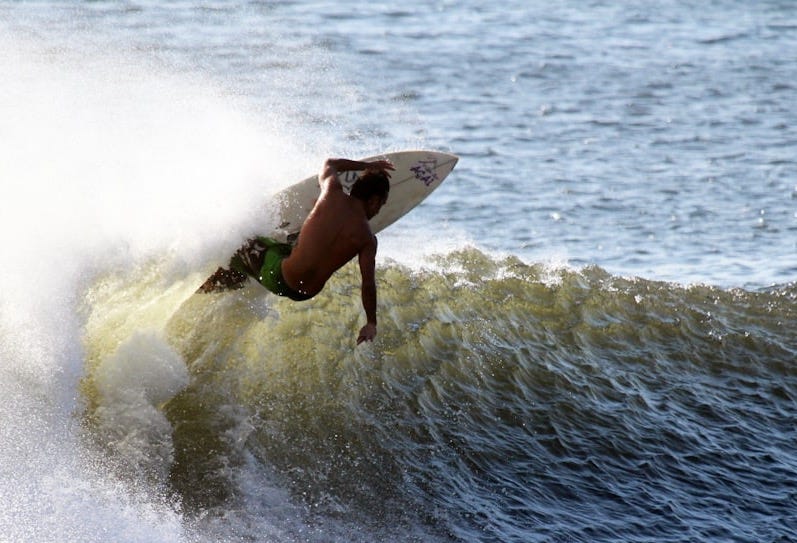 man surfing with white wooden surfboard on sea man surfing with white wooden surfboard on sea
