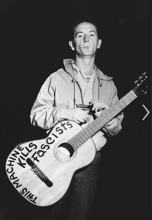 A person holding a guitar

Description automatically generated