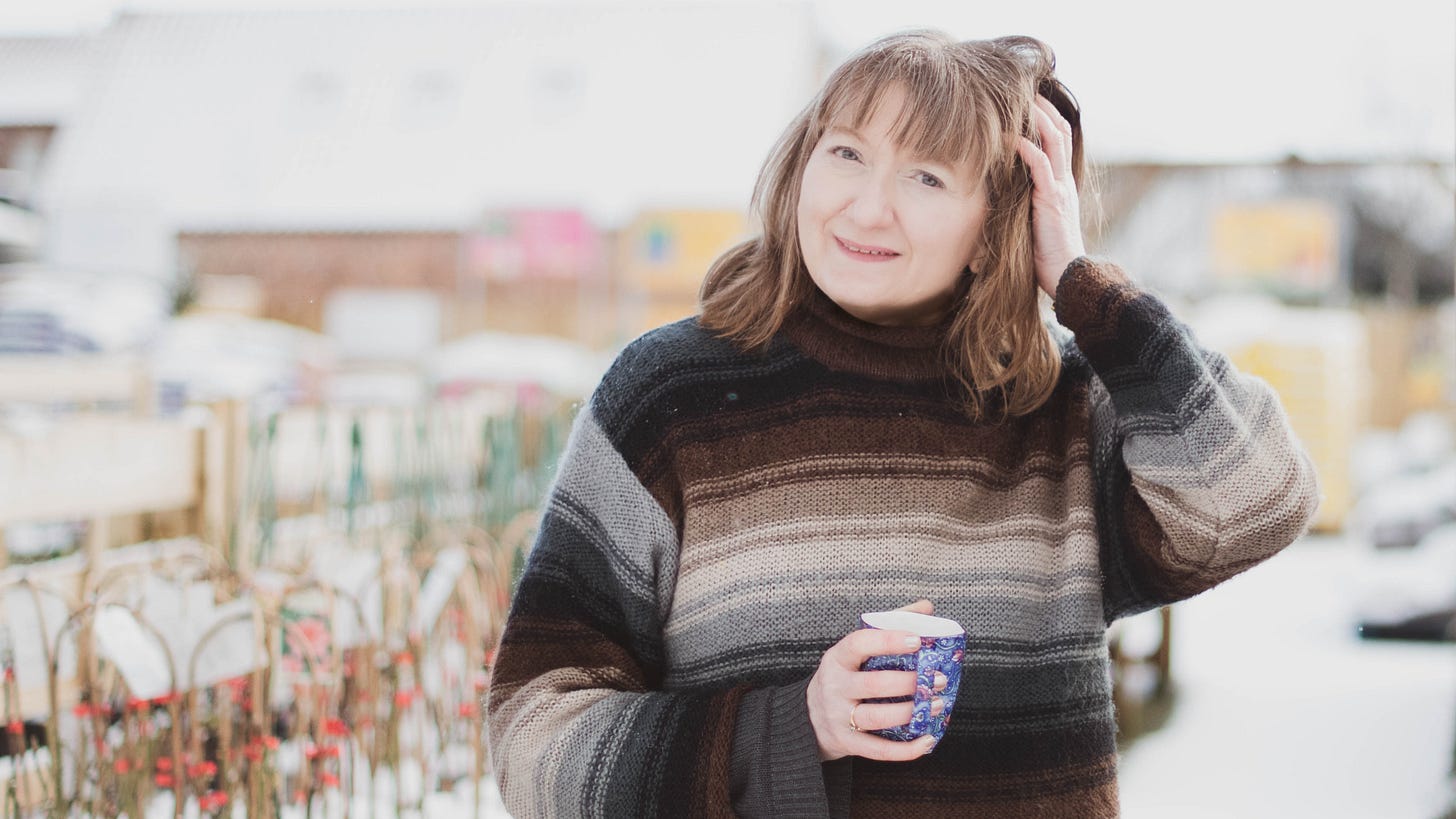 Editor Liz Ryan in howling blizzard wearing fluffy jumper.