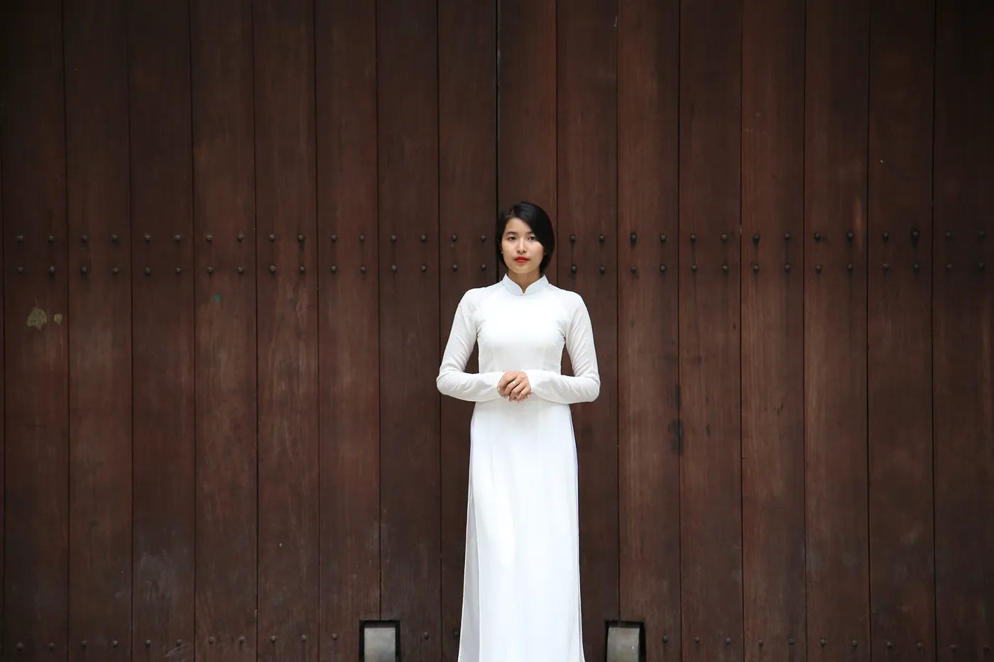 Beautiful Vietnamese woman staying in a long white dress Beautiful Vietnamese woman staying in a long white dress