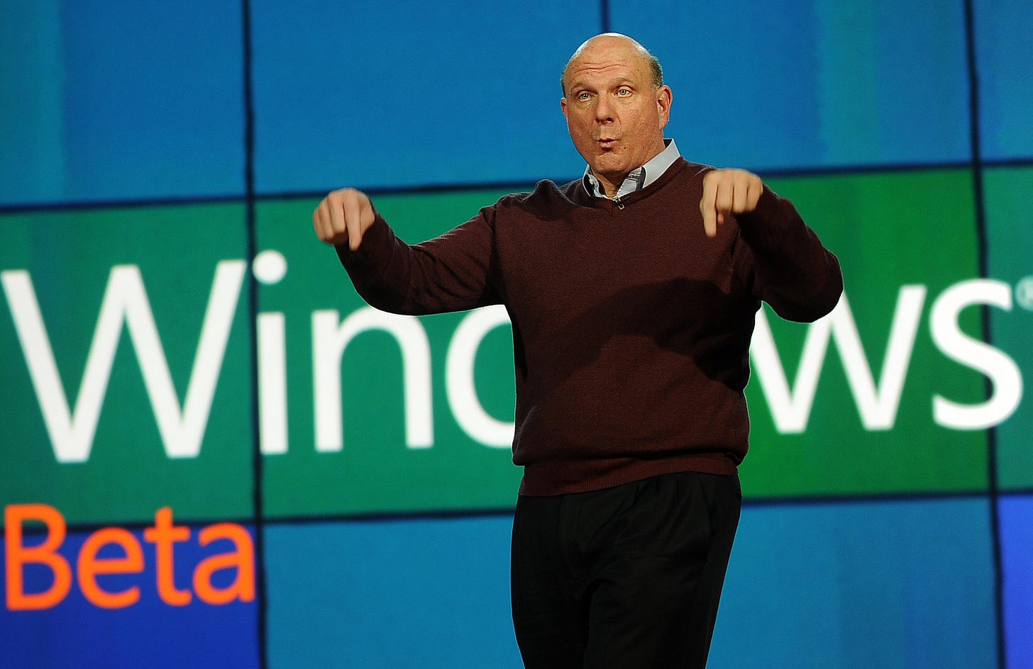 Steve Ballmer on stage with screens behind him saying Windows Beta. Steve Ballmer on stage with screens behind him saying Windows Beta.