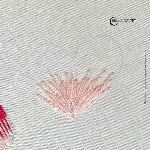 heart template on fabric with pink long and short stitch starting at the bottom