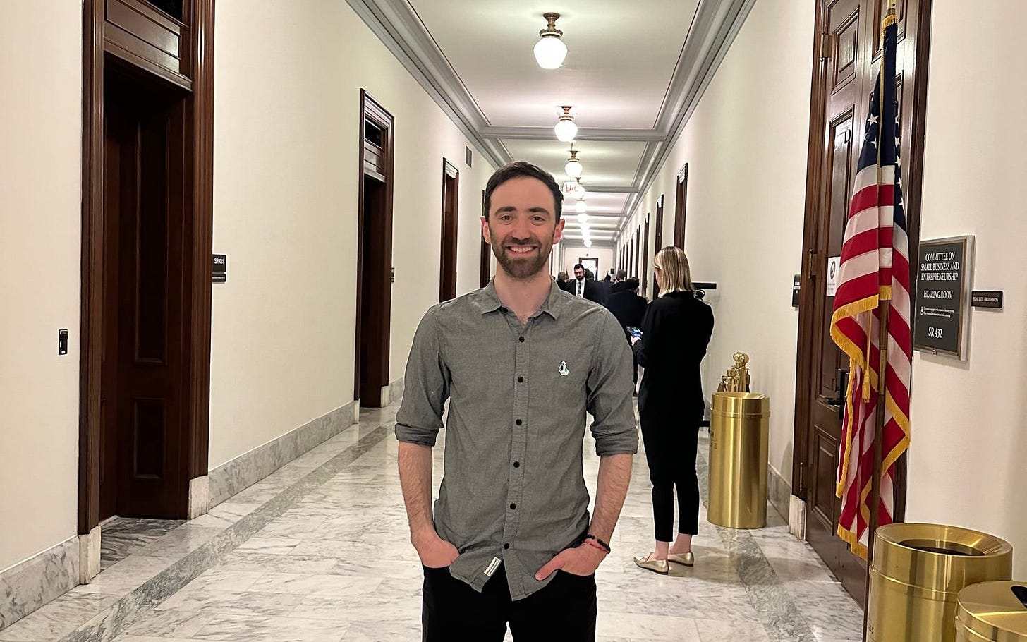 Jacob smiling in the hall of the Senate building