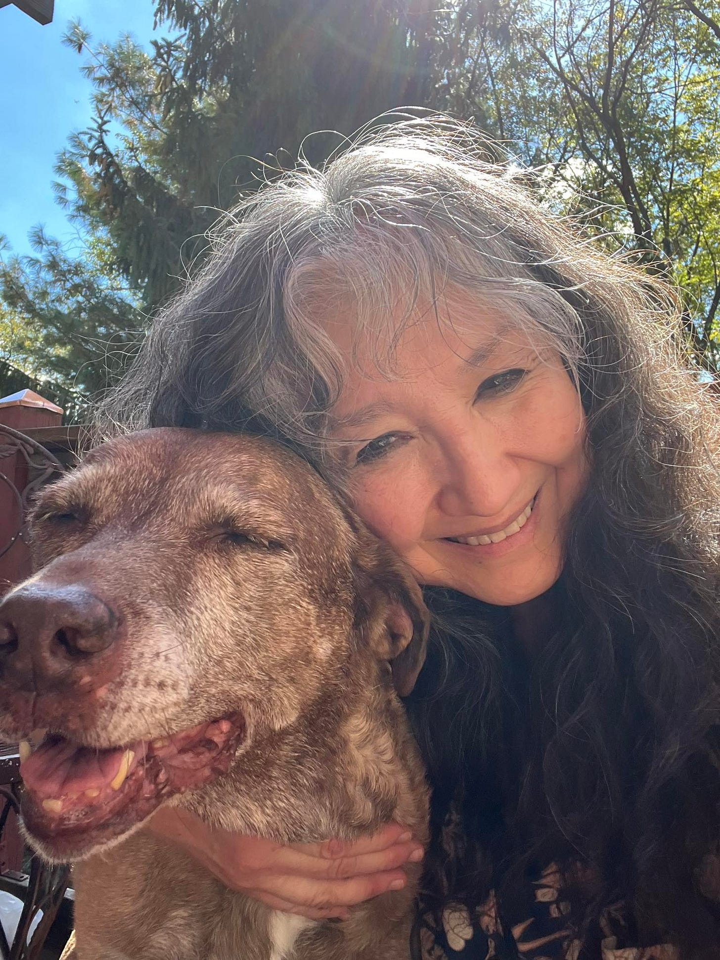 A close up of my very grey, brindle, old girl pittie mix and me (also very grey). 