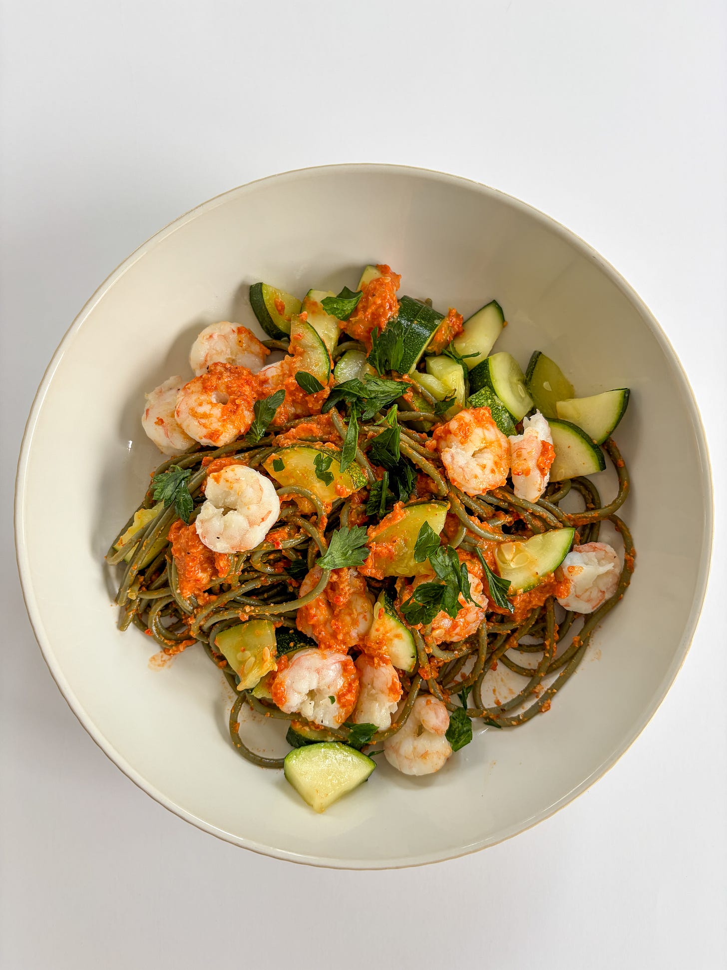 gluten free pasta with romesco, shrimp, zucchini, and parsley