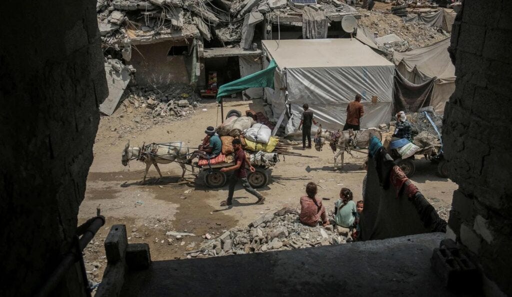 Displaced Palestinians leave the southern neighborhoods on donkey carts following Israeli military orders to evacuate parts of the city in Khan Younis, southern Gaza.