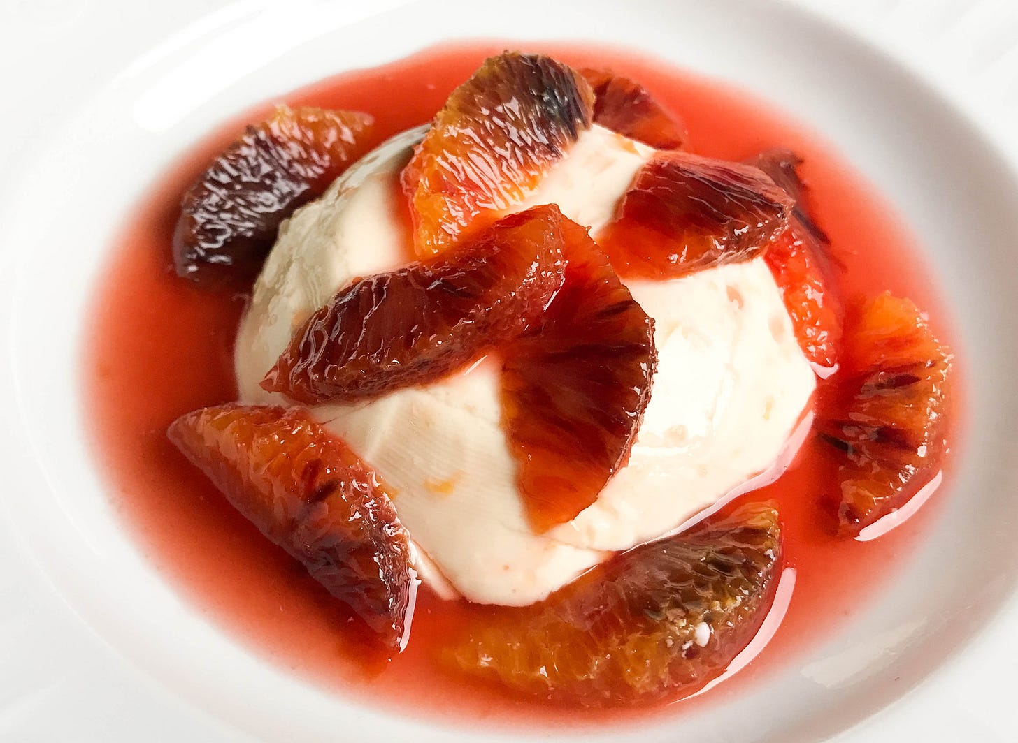 Blood orange panna cotta topped with blood orange compote