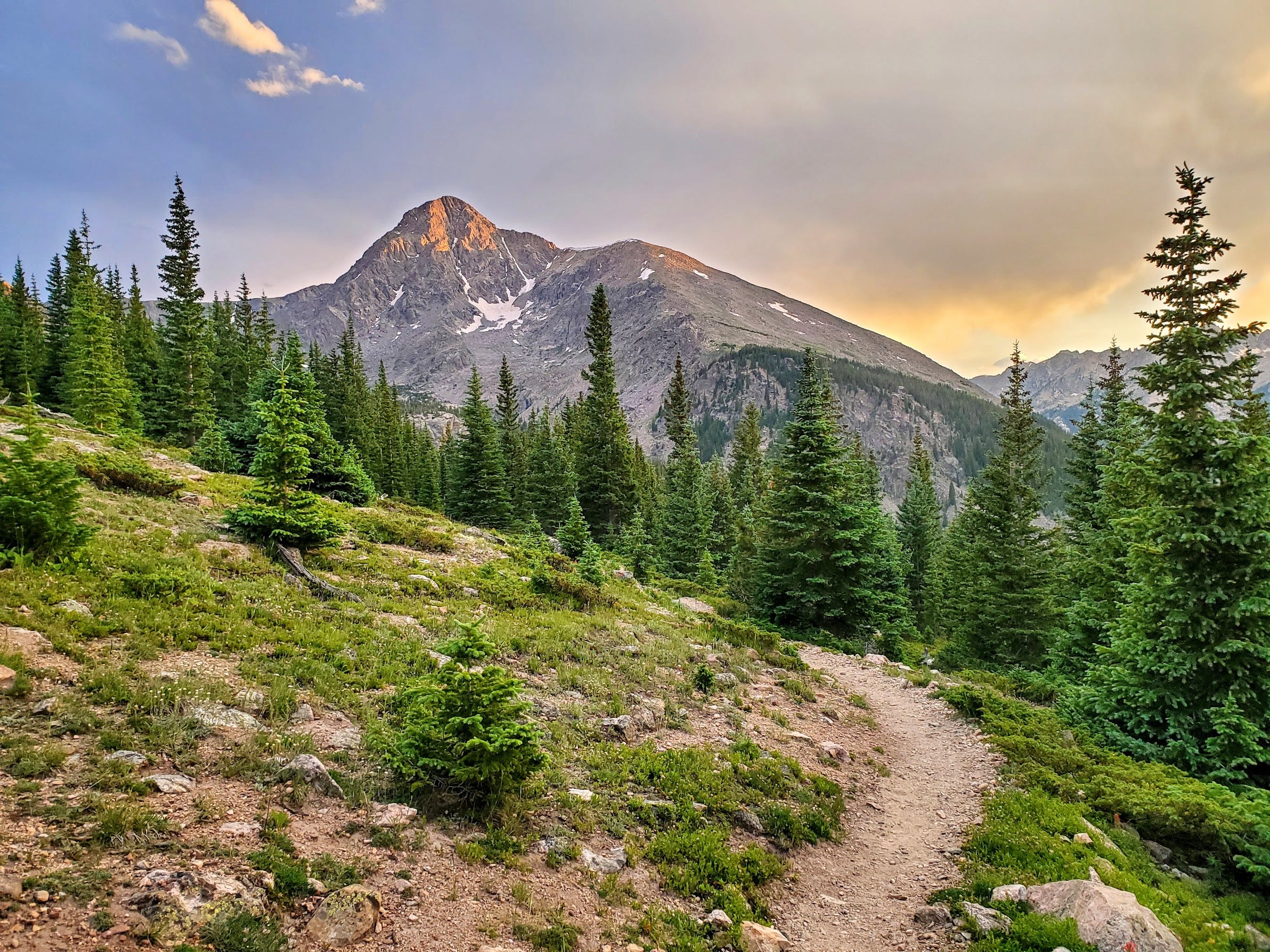 the sun hides behind the mountains ahead