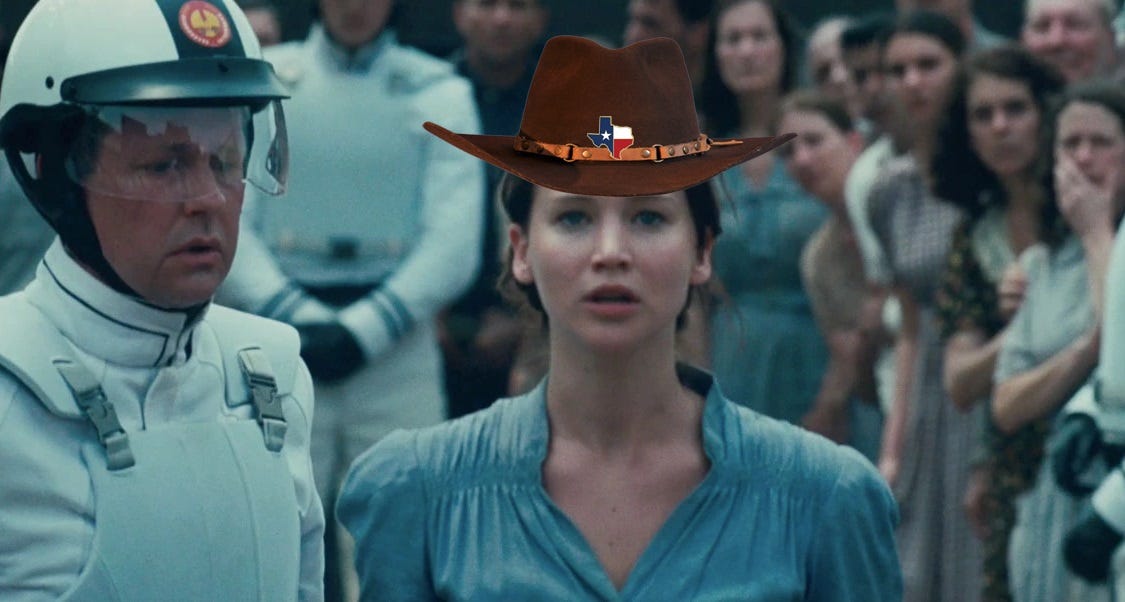 The 'I volunteer as tribute' scene from Hunger Games with a cowboy hat and Texas flag pin photoshopped onto the character's head