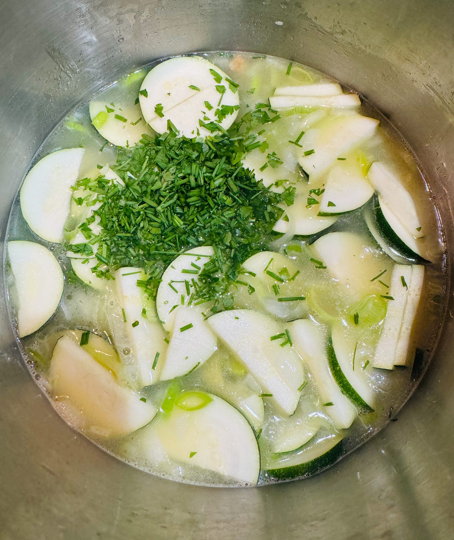Patriot soup of parsley, chives, zucchini, and potatoes simmering in a stock pot, building a vibrant green Irish vegetable soup topped with a swirl of cream and finely shredded carrot in the colors of the Irish flag Patriot soup of parsley, chives, zucchini, and potatoes simmering in a stock pot, building a vibrant green Irish vegetable soup topped with a swirl of cream and finely shredded carrot in the colors of the Irish flag
