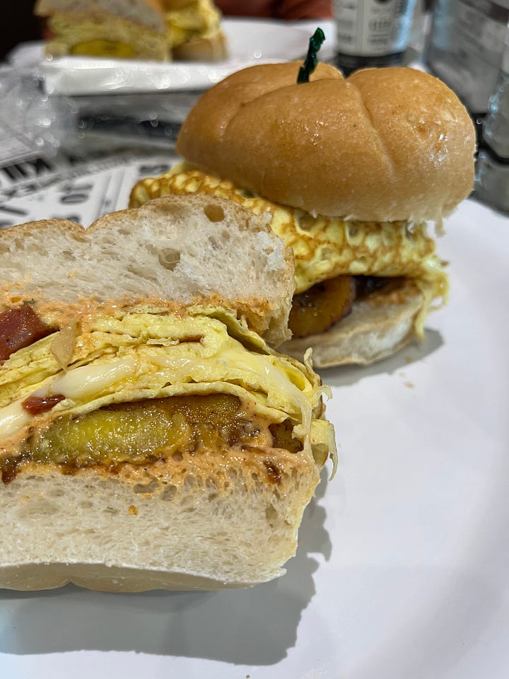 top left: egg, chorizo and plantain breakfast sandwich; top right: chicken tacos; bottom left: ice cream with churro stuck in it; bottom left: smoked salmon pasta and a salad with brie, seafood, walnuts, etc.