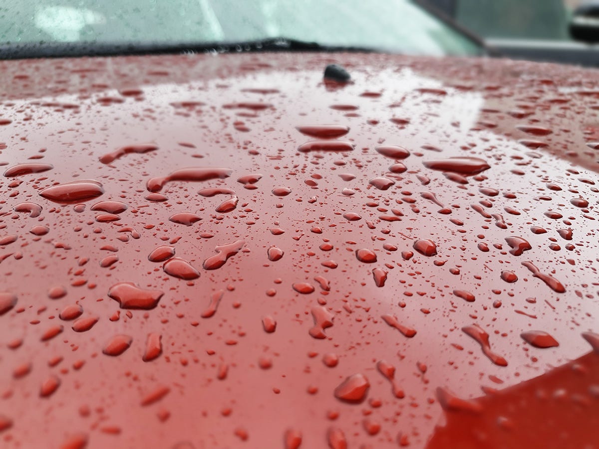 A zoomed in image of the raindrops on the bonnet of the car from the story