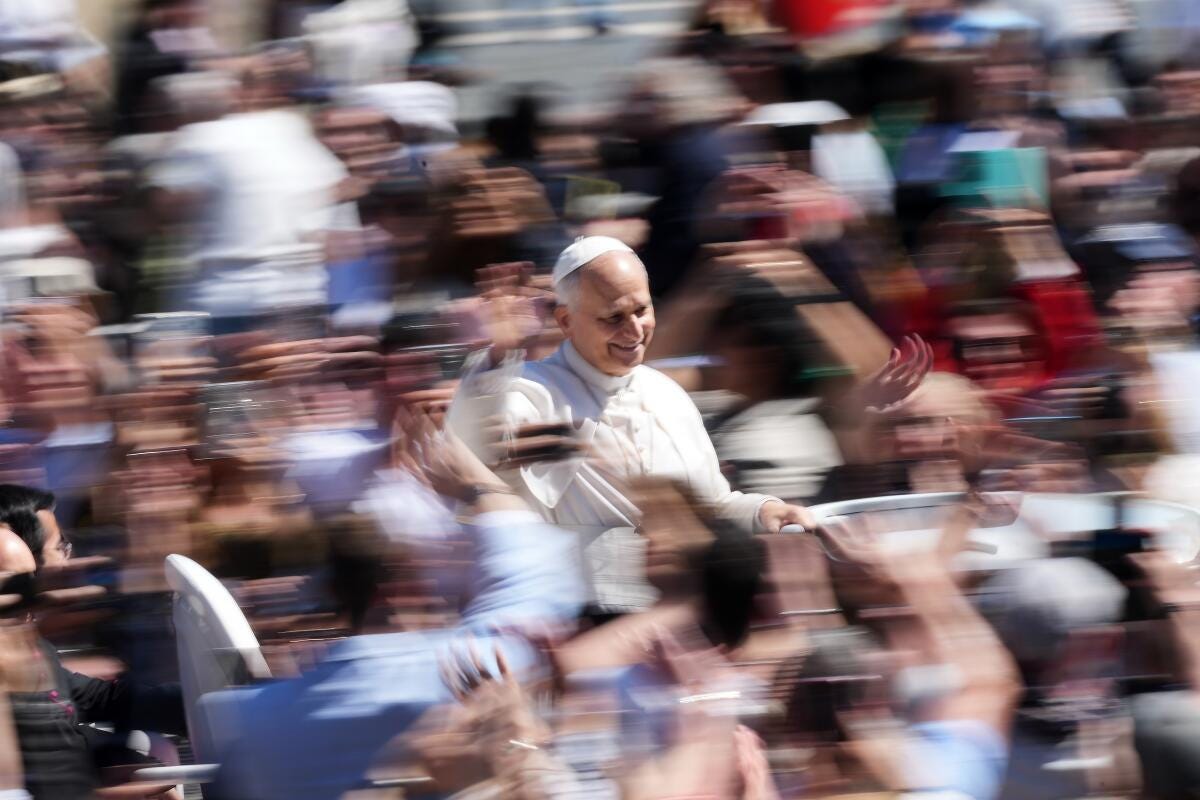Pope Leo XIV greets the faithful at the end of Easter Mass at the Vatican, Sunday, April 5, 2026. 