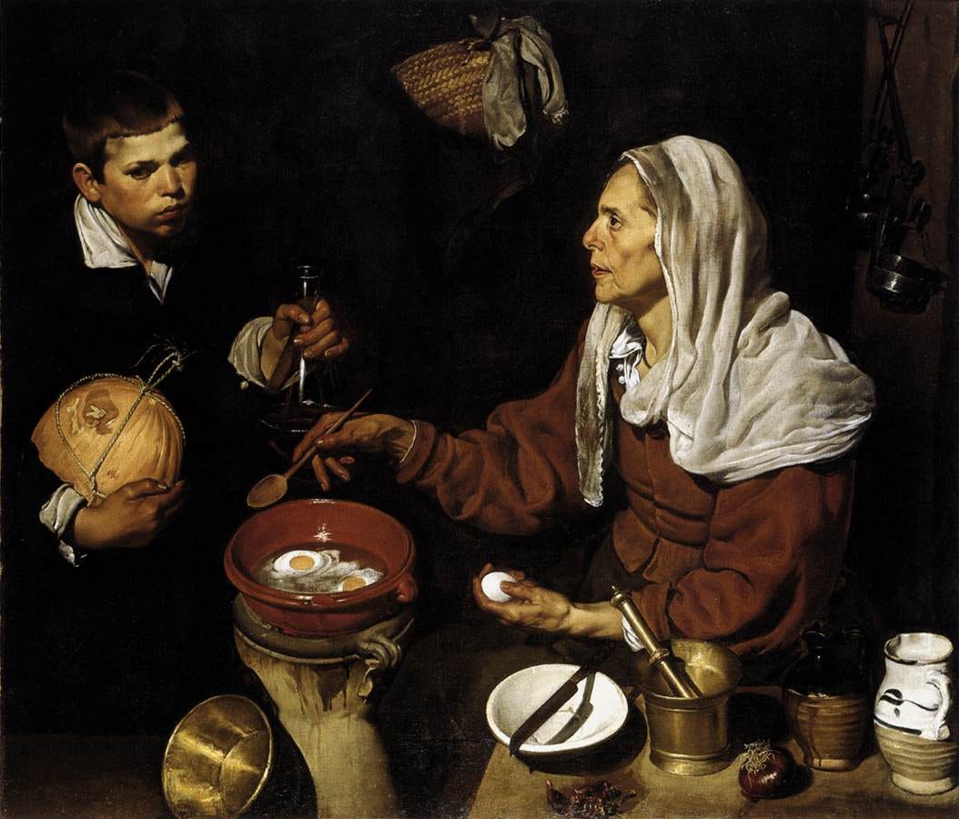Old woman frying eggs