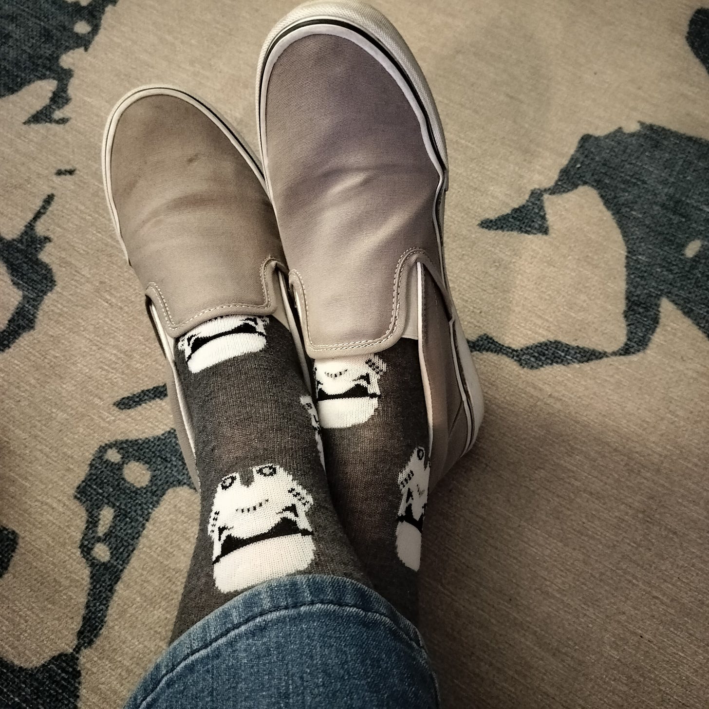 A photo of the Author’s feet crossed at the ankles, wearing Star Wars socks
