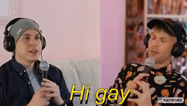 two men wearing headphones are sitting on a couch and one of them is saying hi gay