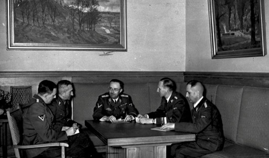 A group of men sitting at a table

AI-generated content may be incorrect.