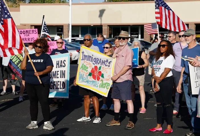 Left: A Peace Rally was held at the Springfield Democratic headquarters on Park Road. Right: A group of Haitian immigrants, Petuel Jeanjacques, Ricardo Omarra, Tamis Giracia, and Joseph Nelius, participate in the Peace Rally. Photo: Bill Lackey/Springfield News-Sun, Sept. 18, 2024.