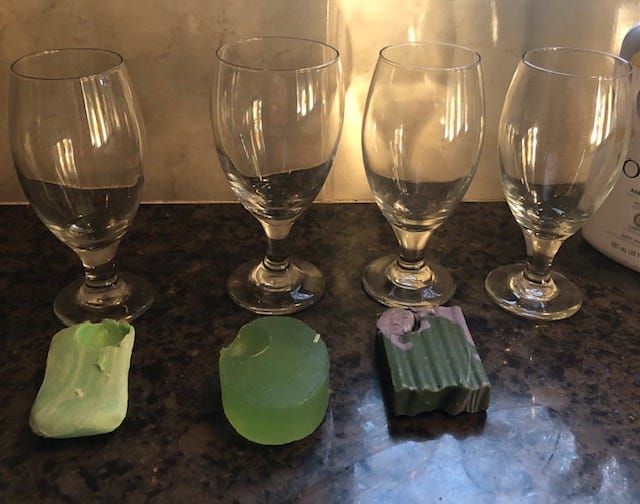 A row of wine glasses and soap

Description automatically generated
