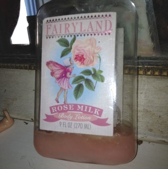 This may contain: a bottle filled with rose milk sitting on top of a counter