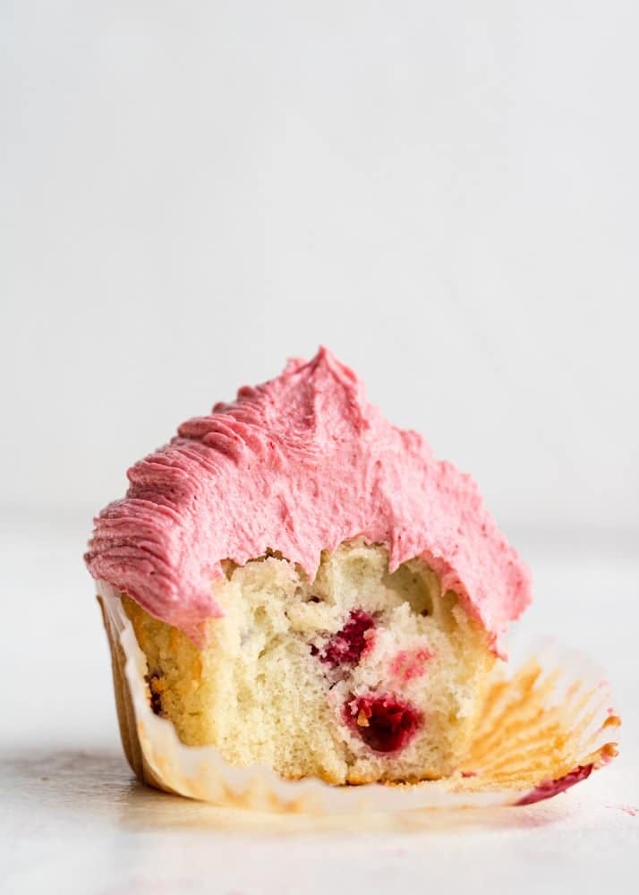 A raspberry cupcake topped with creamy raspberry buttercream
