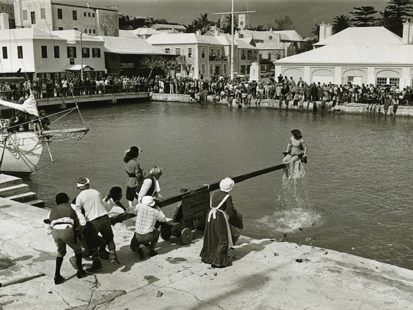 A group of people watching a child jumping into the water

AI-generated content may be incorrect.