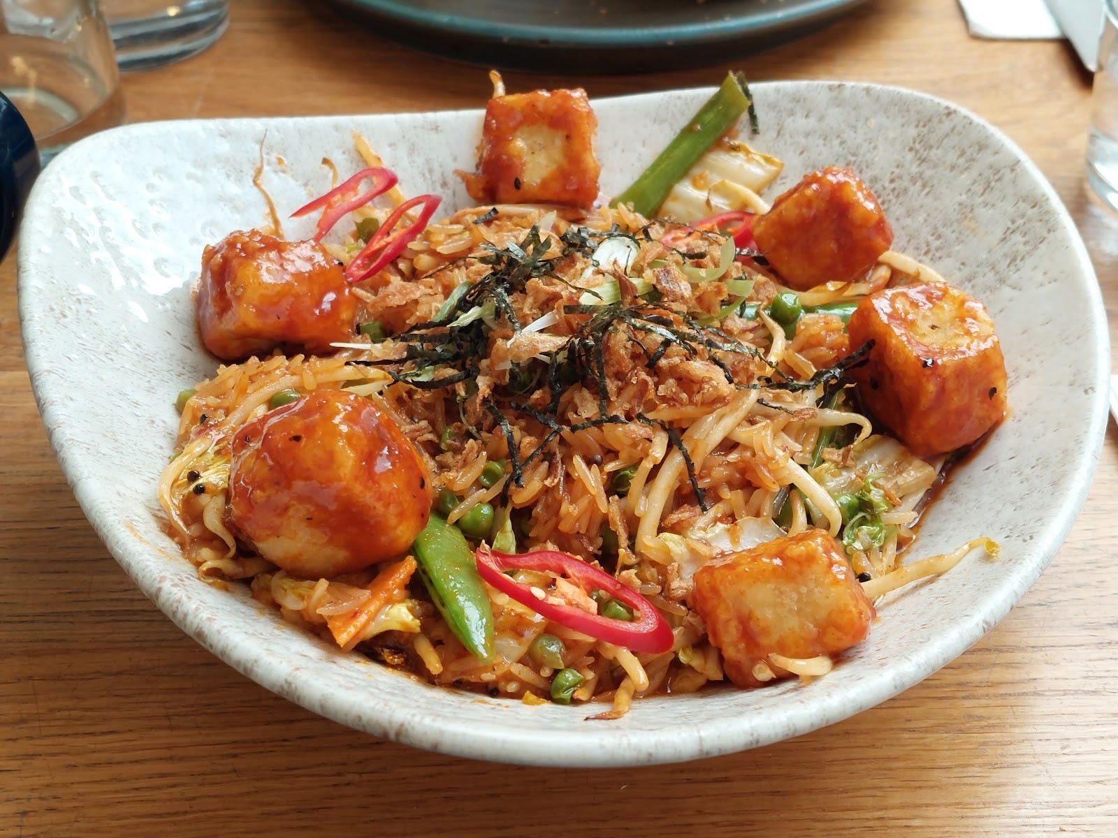 Photo of a bowl of Korean style rice with tofu and kimchi.