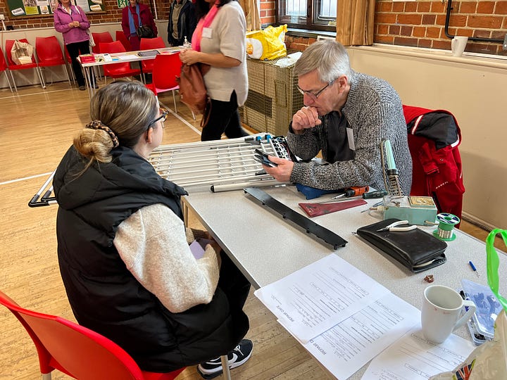People at work fixing peoples’ broken home appliances at a weekend repair cafe