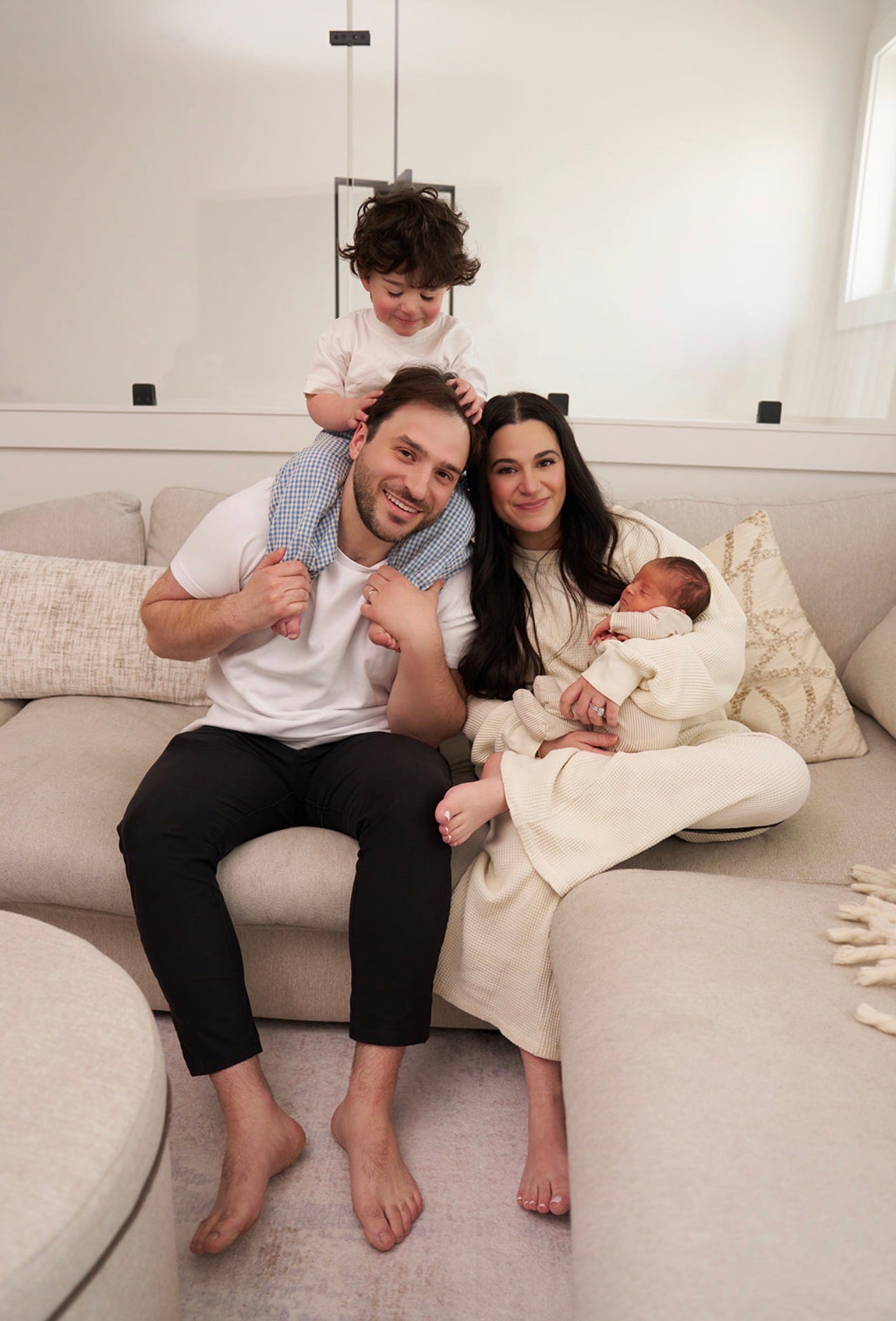 Jamie sitting on the couch with her husband and two children, photo by Hailey York Jamie sitting on the couch with her husband and two children, photo by Hailey York