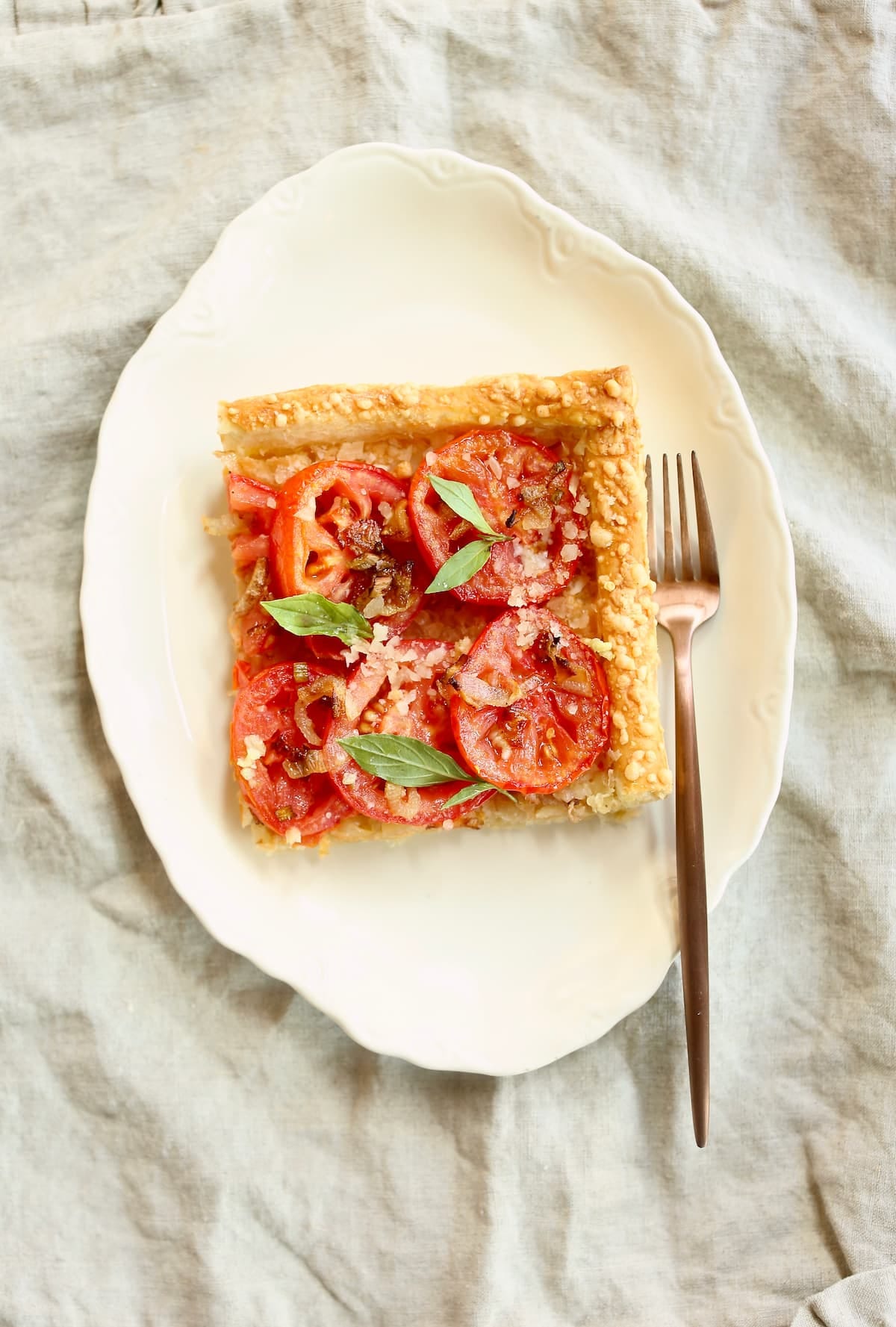 an overhead photo of a square piece of tomato pie.