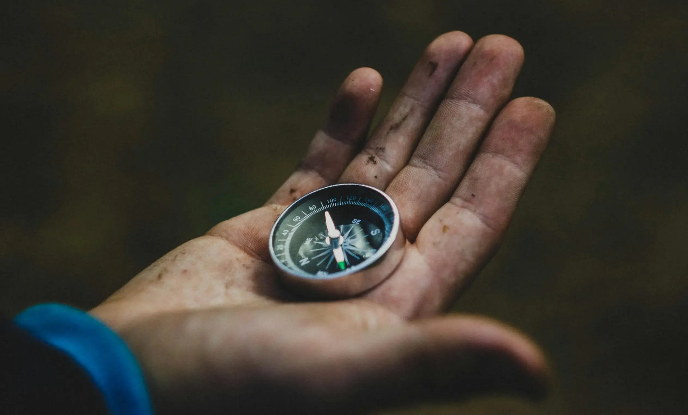 man holding a compass in his hand to find a new direction for his life