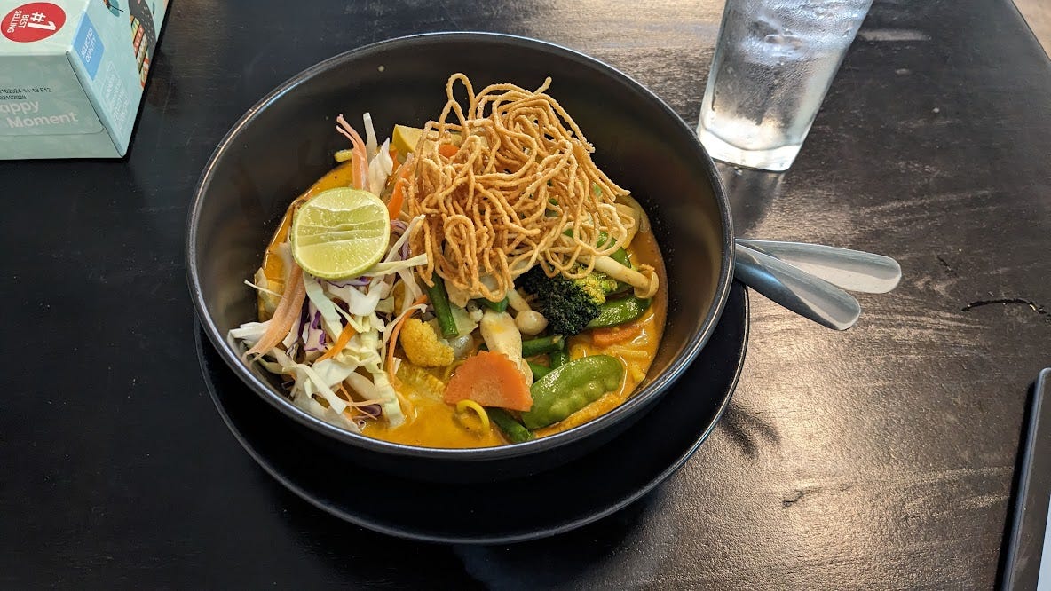bowl of colorful khao soi curry