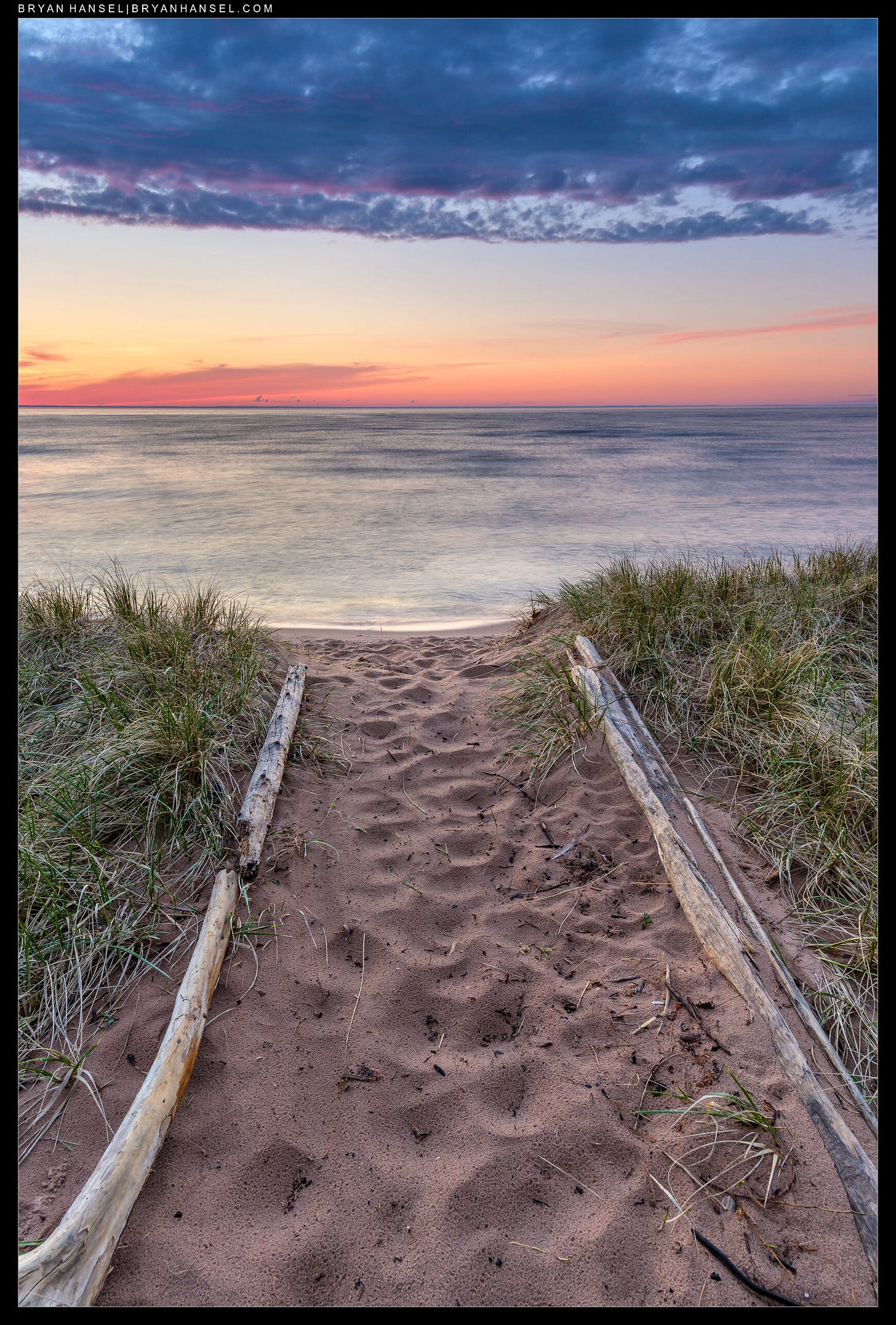 A small sand walkway pointing to the big lake.