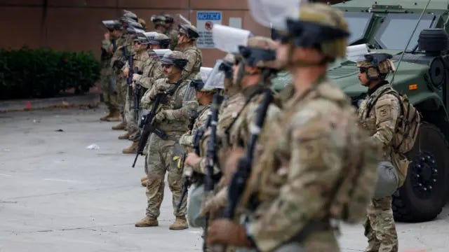 Members of the National Guard stand guard in front of the Federal building in Los Angeles