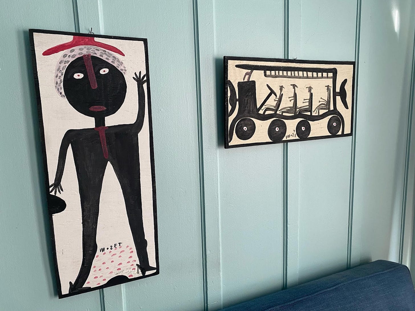 A wall with paintings on it

AI-generated content may be incorrect.