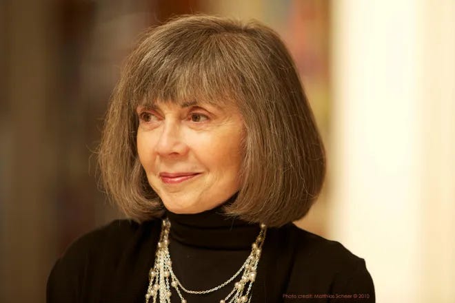A photo of the late author Anne Rice, looking to her right. Her hair is in a gray bob and she is wearing a black turtleneck and gold necklaces. She's smiling slightly. A photo of the late author Anne Rice, looking to her right. Her hair is in a gray bob and she is wearing a black turtleneck and gold necklaces. She's smiling slightly.