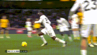 a soccer player wearing number 23 runs toward the ball