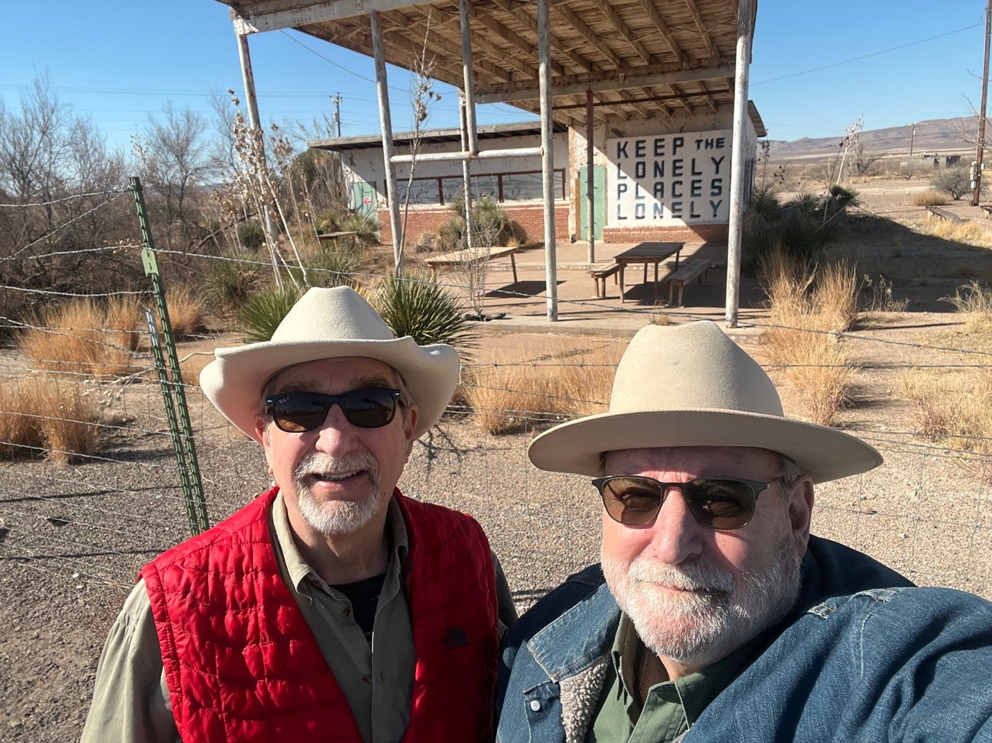 Two men wearing cowboy hats and sunglasses

Description automatically generated