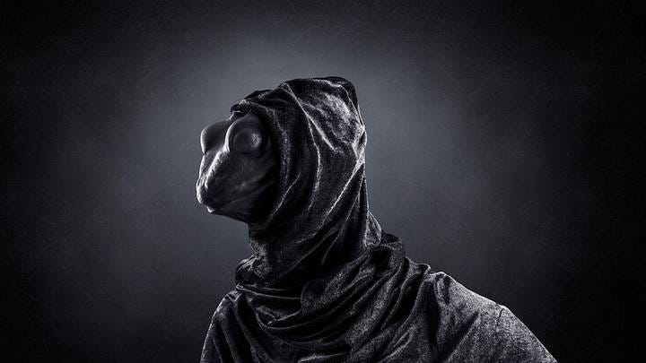Lizard-shaped man over misty dark background | Jakub Krechowicz / Shutterstock