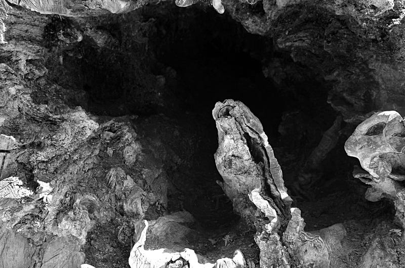 a dark craggy hole or cavern, or cleft a dark craggy hole or cavern, or cleft
