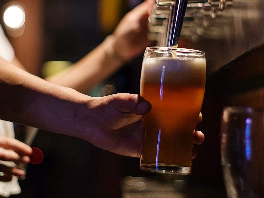 person holding drinking glass person holding drinking glass