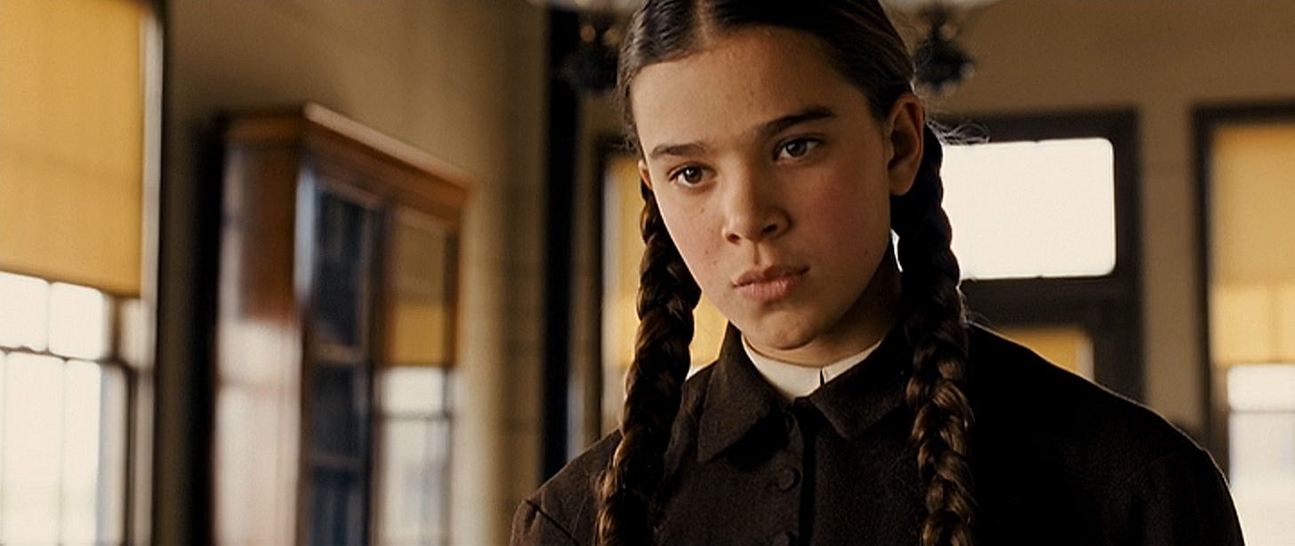 Serious girl with pigtails in a bank