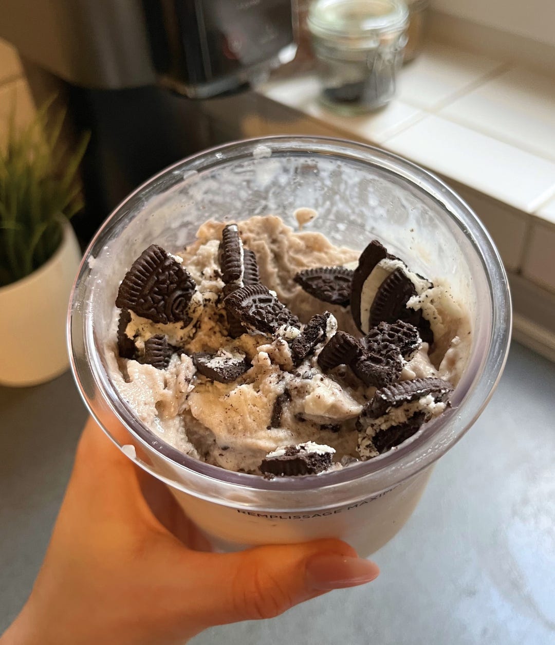 A close-up of a protein-packed Oreo ice cream served in a bowl, showcasing the creamy consistency and pieces of crushed Oreo mixed throughout.