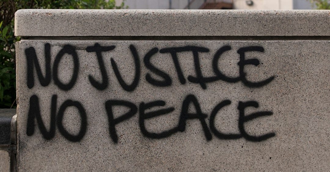 a cement wall with graffiti written on it
