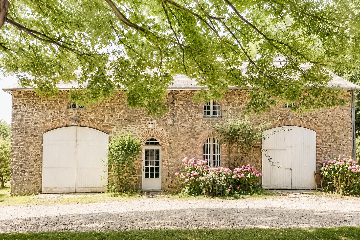 Finished stone coach house in rural France on a sunny day.
