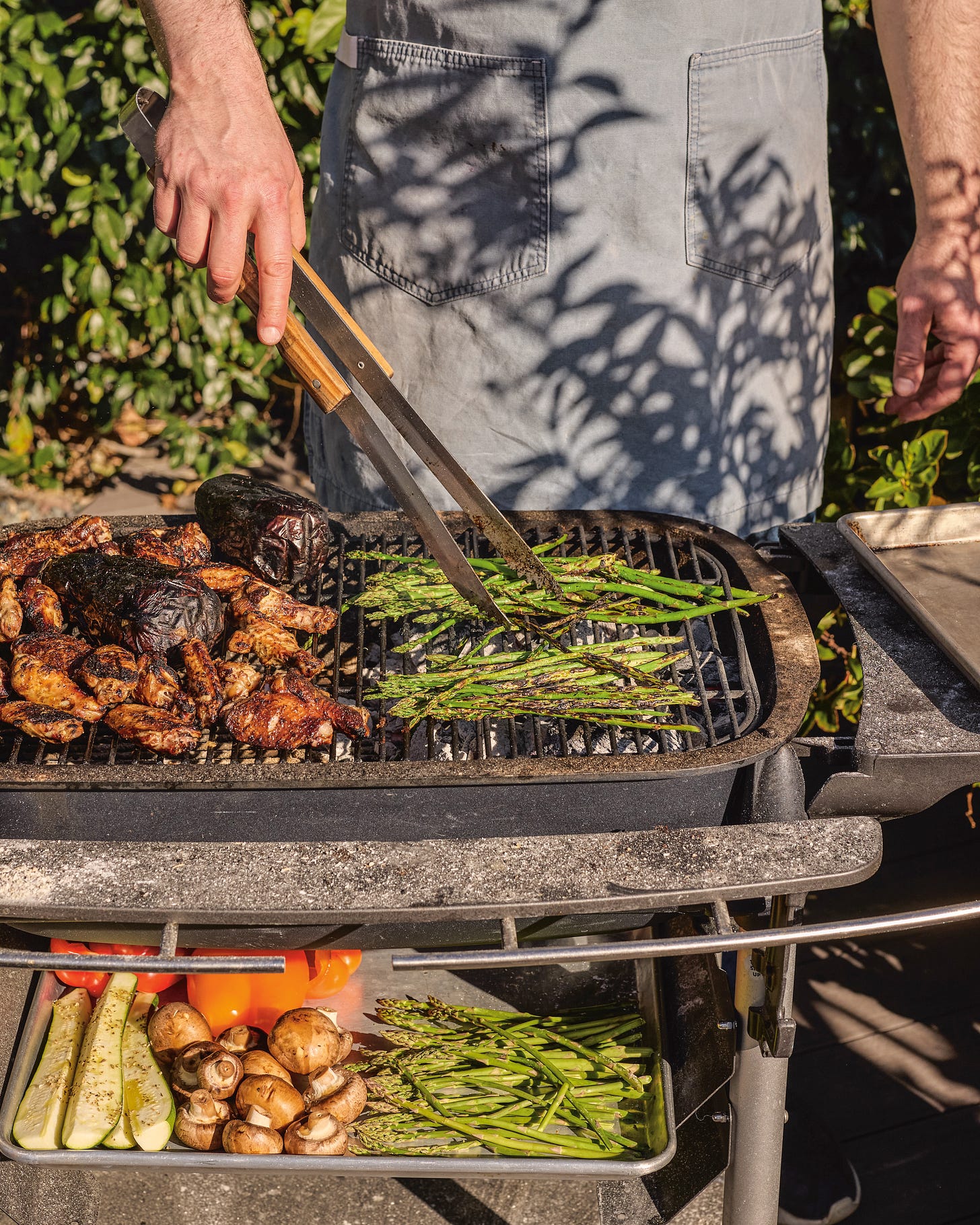 Noah grilling asparagus and a variety of meats (Photo Credit: Kristin Teig)